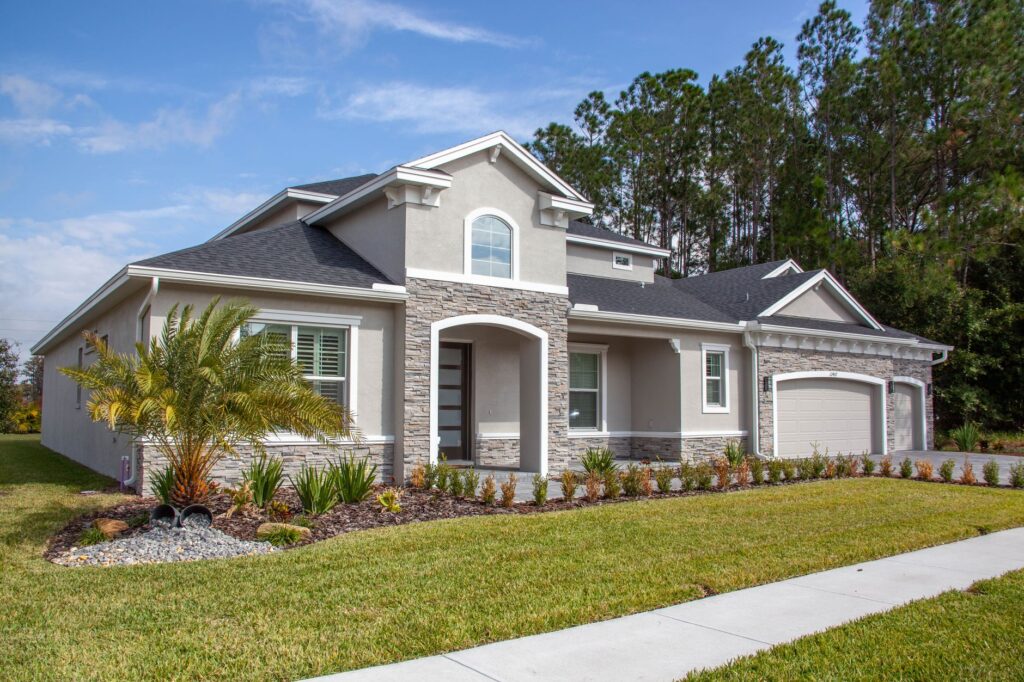Florida stucco home with an asphalt shingle roof